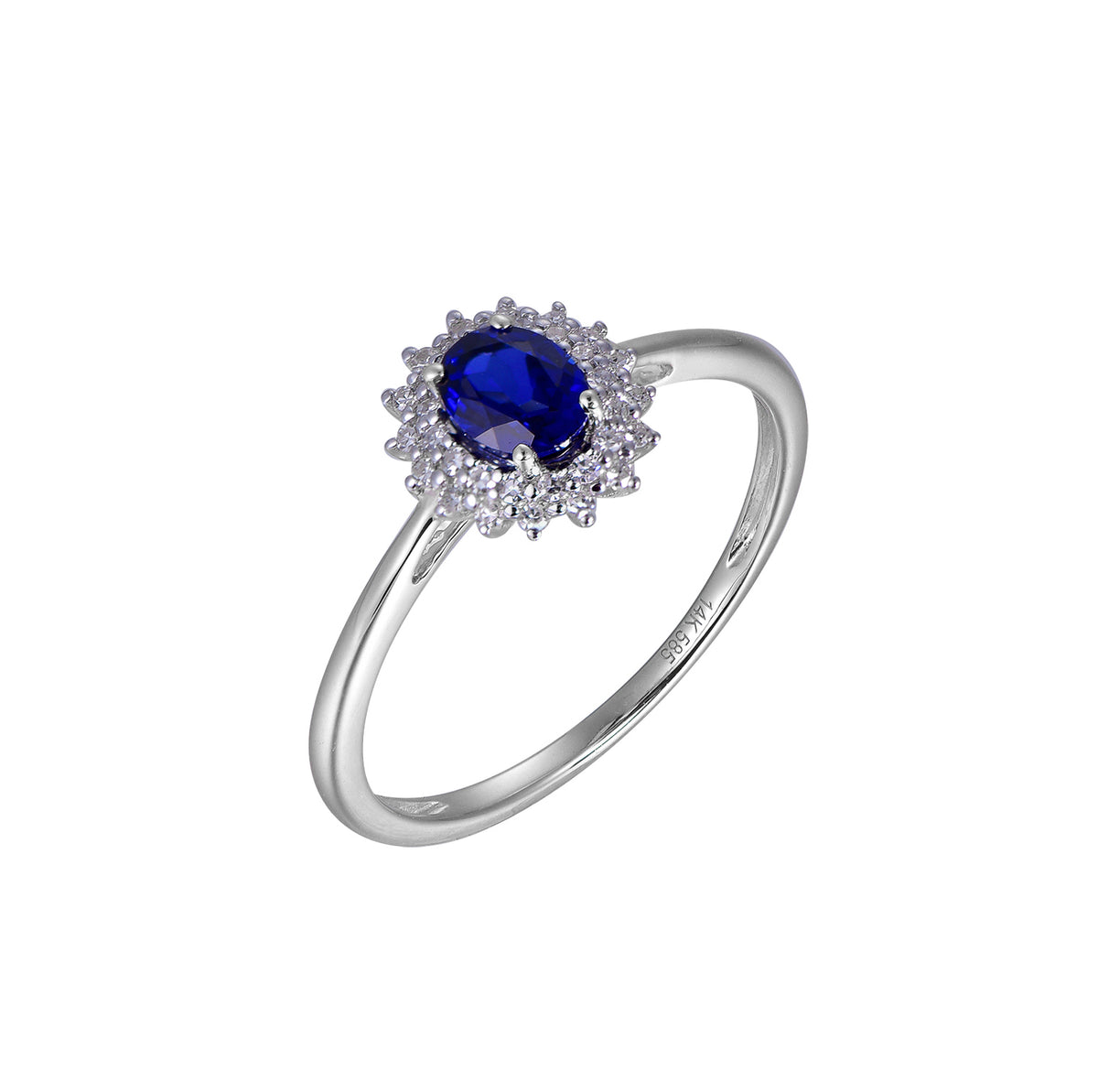 A white gold ring featuring an oval-cut deep blue center stone surrounded by a halo of small clear stones, set on a plain white background.